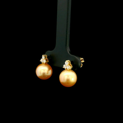 South Sea golden pearl and diamond stud earrings in 18K yellow gold with 8 x 8.5 mm pearls and three-diamond accents