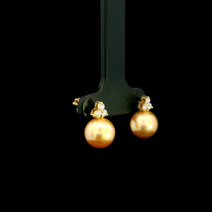 South Sea golden pearl and diamond stud earrings in 18K yellow gold with 8 x 8.5 mm pearls and three-diamond accents