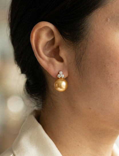 South Sea golden pearl and diamond stud earrings in 18K yellow gold with 8 x 8.5 mm pearls and three-diamond accents