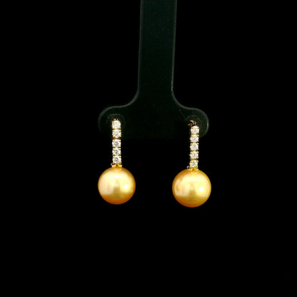 South Sea golden pearl and diamond earrings in 18K yellow gold with diamond-set bars and round golden pearls