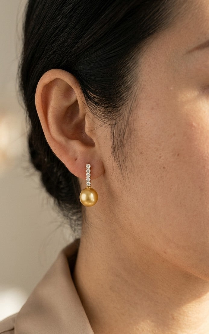 South Sea golden pearl and diamond earrings in 18K yellow gold with diamond-set bars and round golden pearls