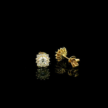 Diamond halo stud earrings in 18K yellow gold with round centre diamonds surrounded by smaller round diamonds.