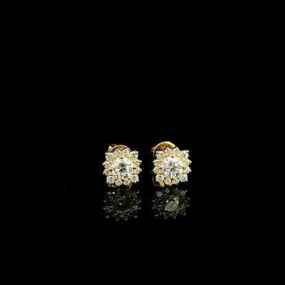 Diamond halo stud earrings in 18K yellow gold with round centre diamonds surrounded by smaller round diamonds.