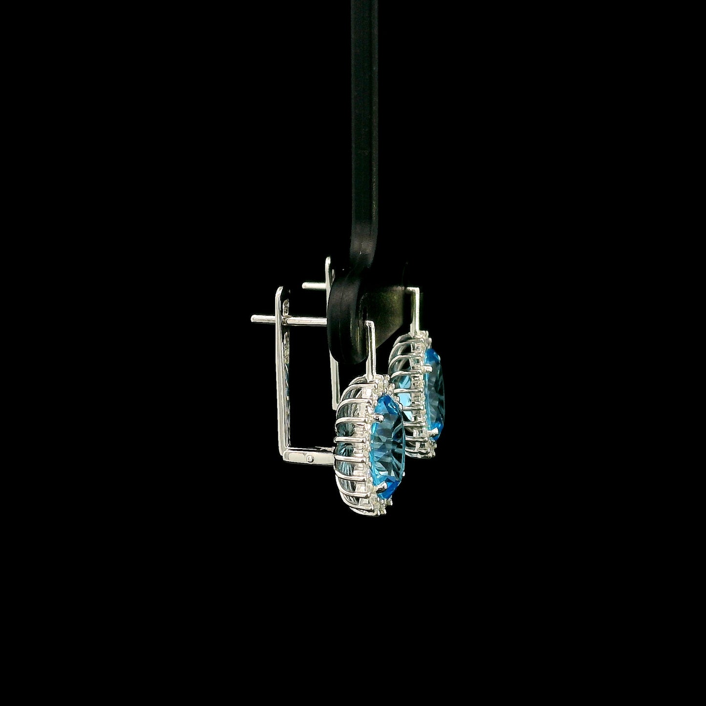 Oval Swiss Blue Topaz drop earrings with diamond halos in 18K white gold