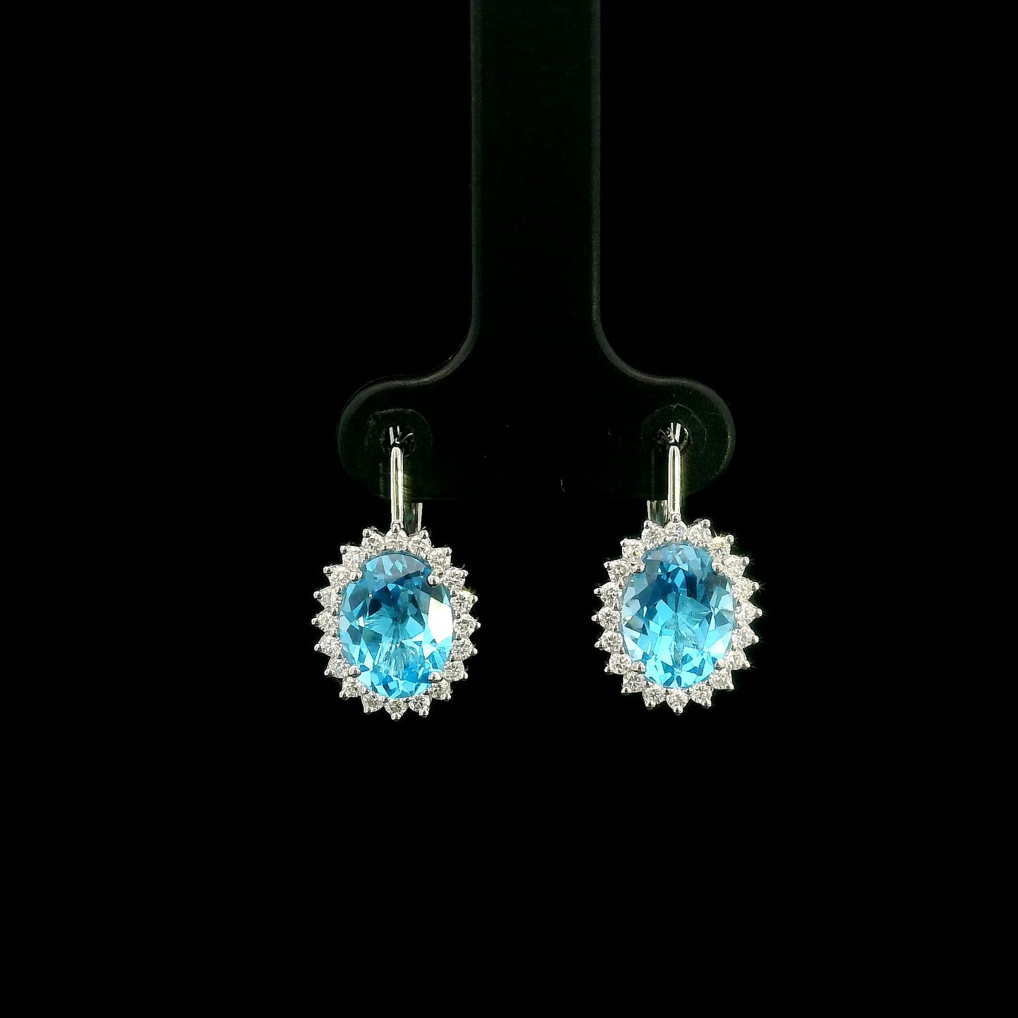 Oval Swiss Blue Topaz drop earrings with diamond halos in 18K white gold