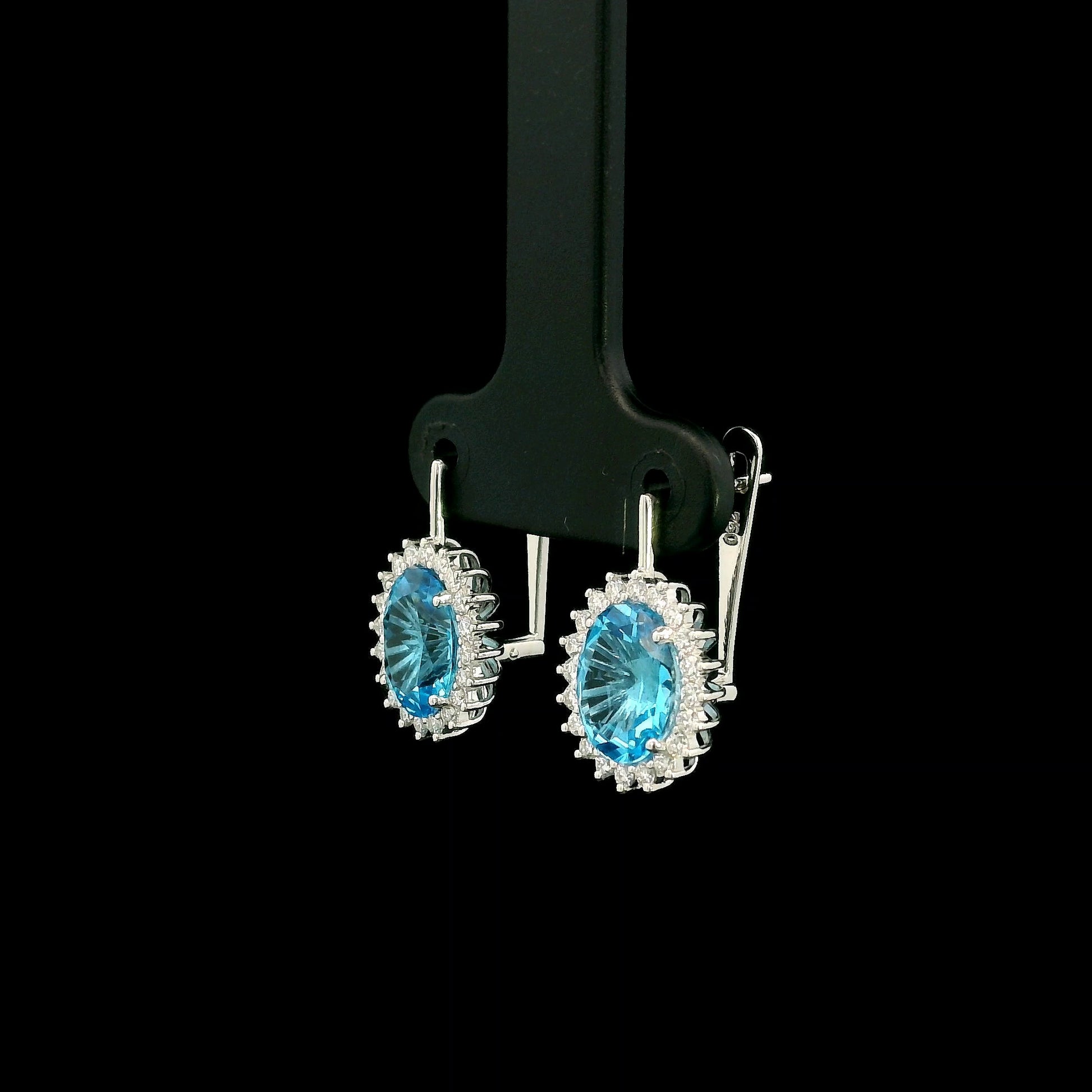 Oval Swiss Blue Topaz drop earrings with diamond halos in 18K white gold