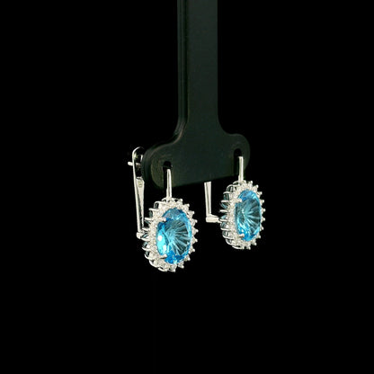 Oval Swiss Blue Topaz drop earrings with diamond halos in 18K white gold