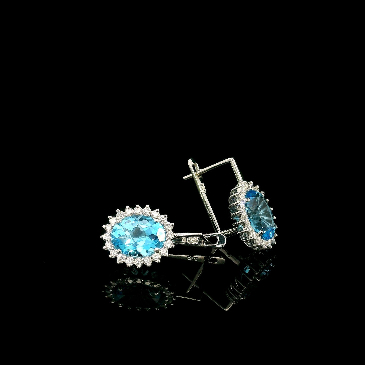 Oval Swiss Blue Topaz drop earrings with diamond halos in 18K white gold