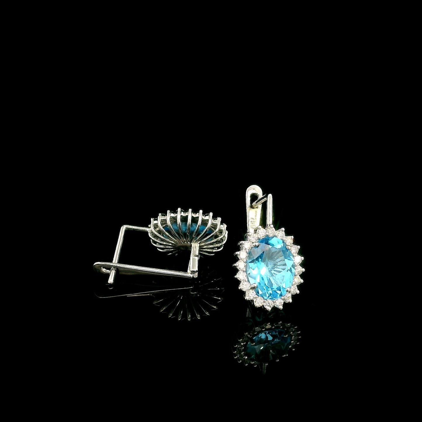 Oval Swiss Blue Topaz drop earrings with diamond halos in 18K white gold