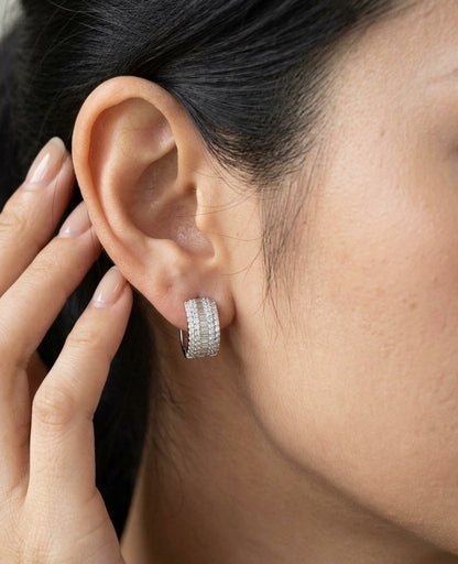 Baguette and round diamond hoop earrings in 18K white gold featuring a central baguette diamond row framed by round brilliant diamonds.