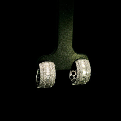 Baguette and round diamond hoop earrings in 18K white gold featuring a central baguette diamond row framed by round brilliant diamonds.