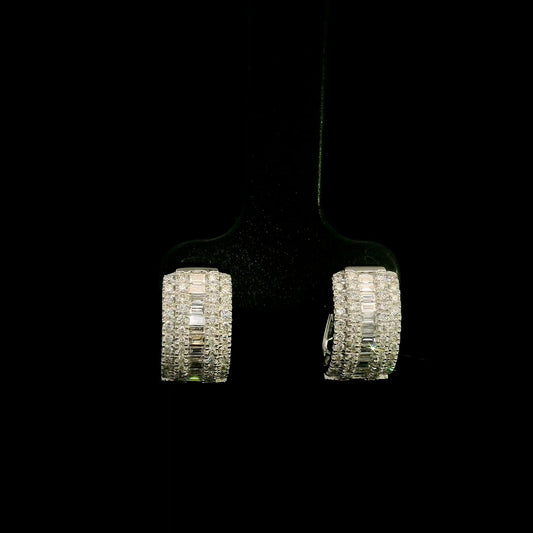 Baguette and round diamond hoop earrings in 18K white gold featuring a central baguette diamond row framed by round brilliant diamonds.