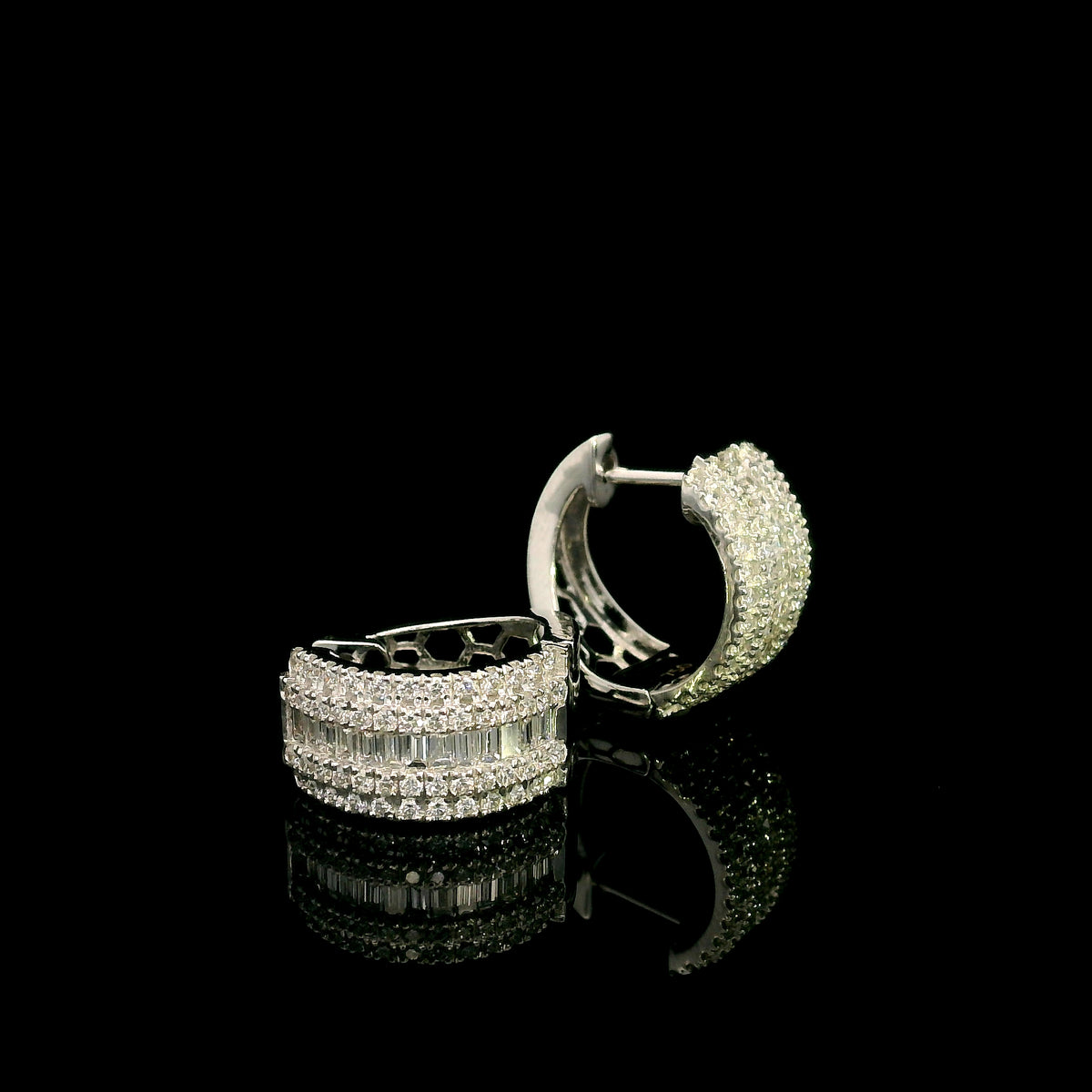 Baguette and round diamond hoop earrings in 18K white gold featuring a central baguette diamond row framed by round brilliant diamonds.