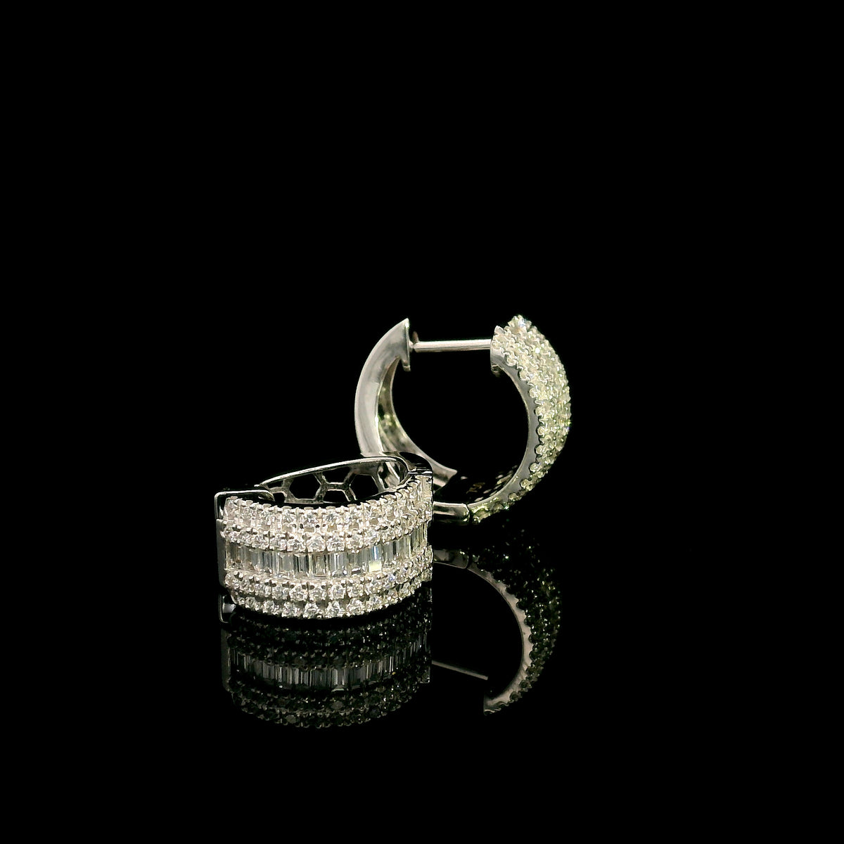 Baguette and round diamond hoop earrings in 18K white gold featuring a central baguette diamond row framed by round brilliant diamonds.