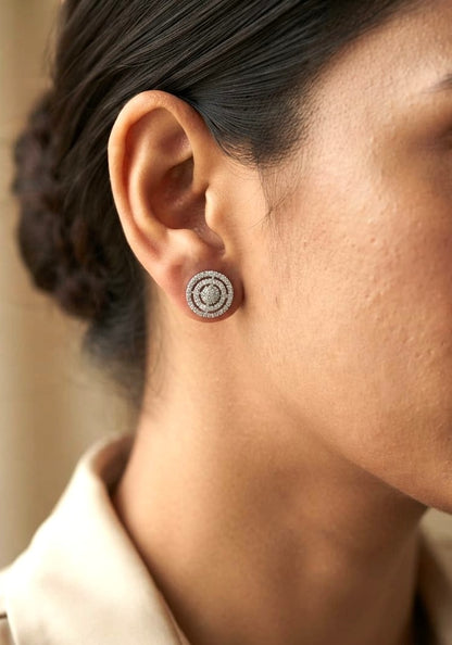 Diamond circle stud earrings in 18K white gold featuring concentric rows of round brilliant diamonds.