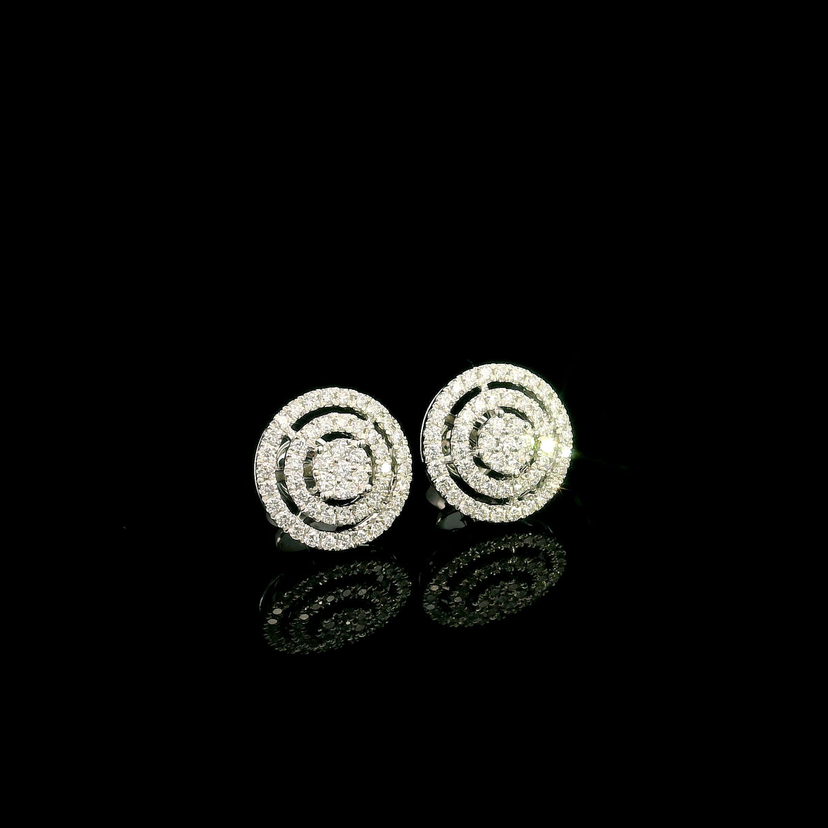 Diamond circle stud earrings in 18K white gold featuring concentric rows of round brilliant diamonds.