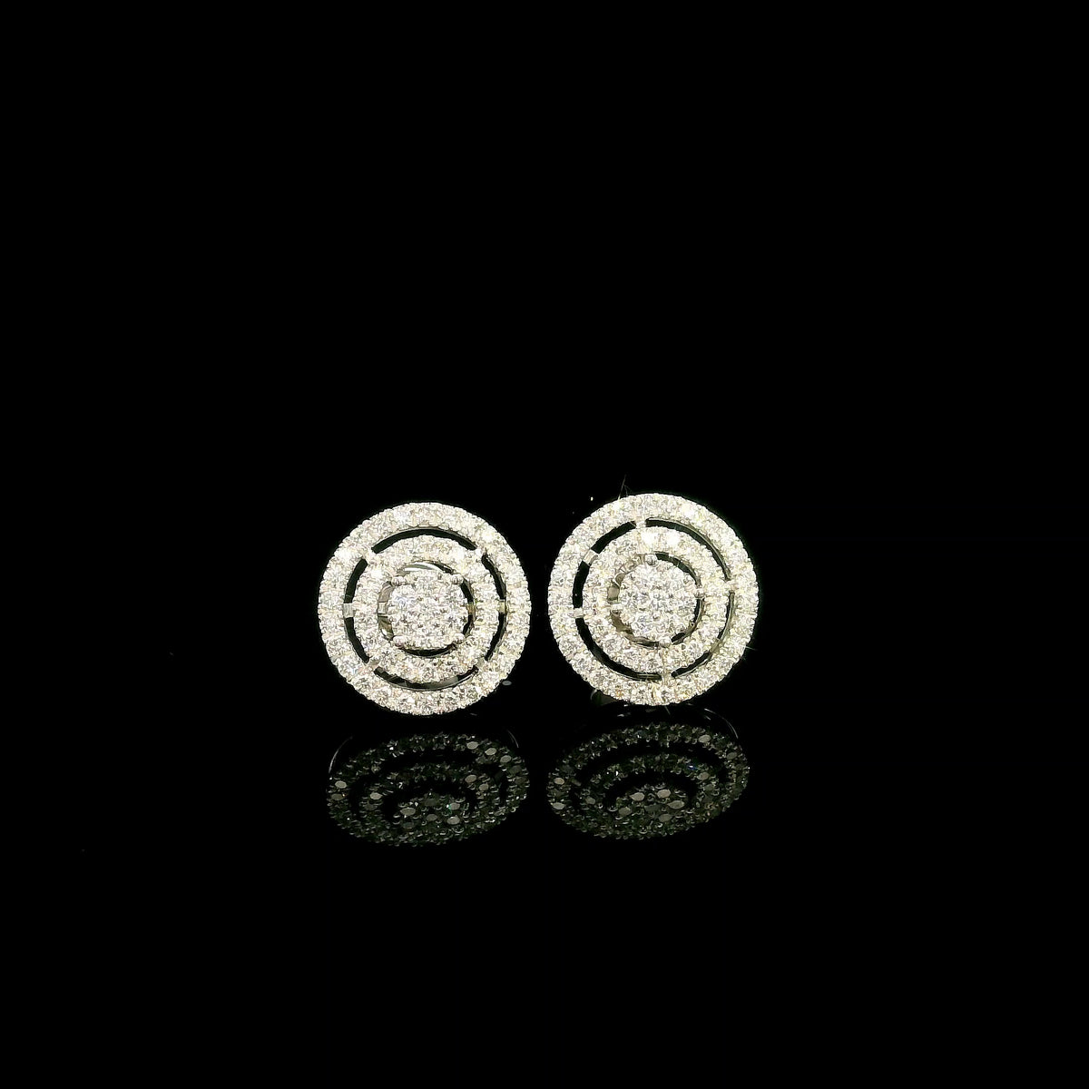 Diamond circle stud earrings in 18K white gold featuring concentric rows of round brilliant diamonds.