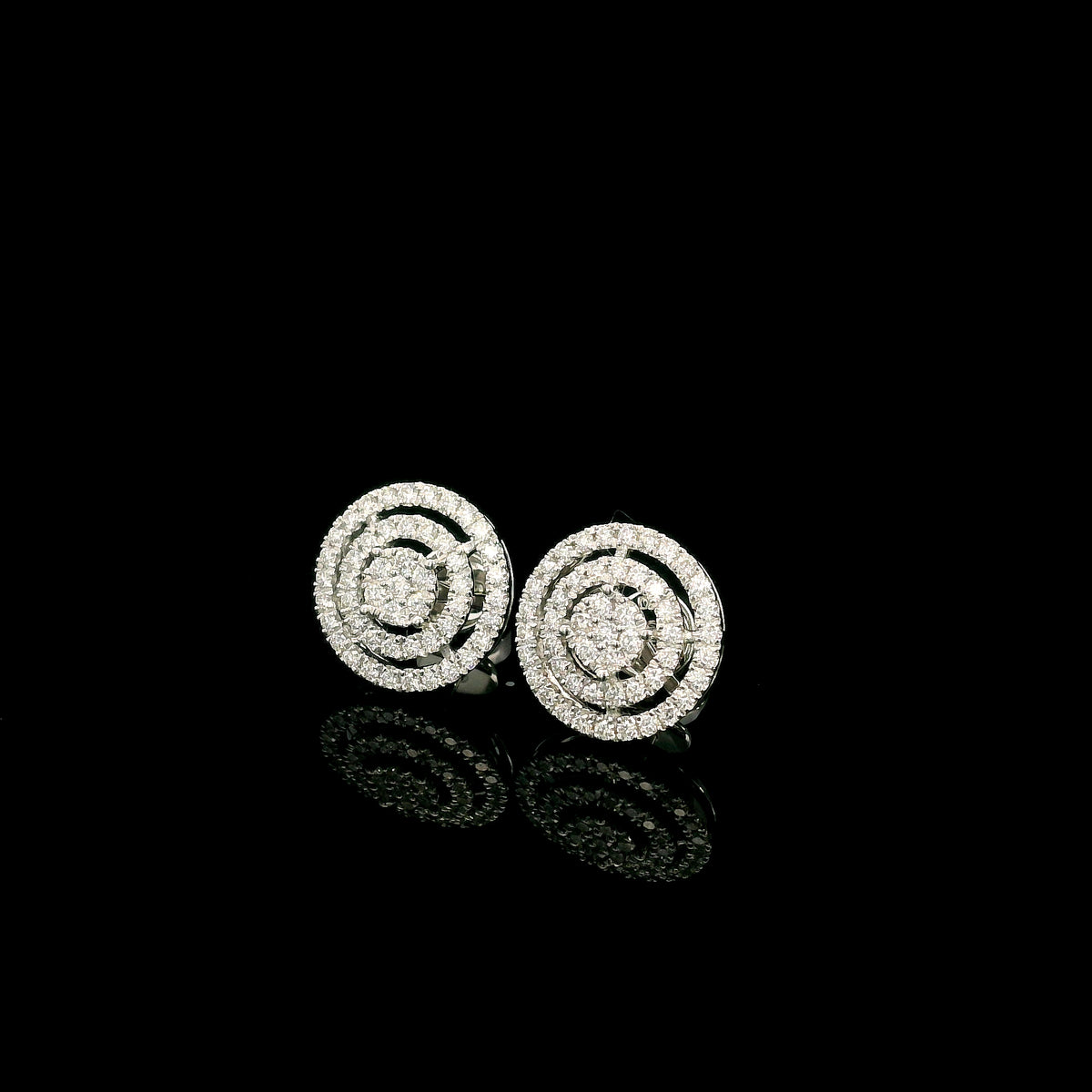 Diamond circle stud earrings in 18K white gold featuring concentric rows of round brilliant diamonds.