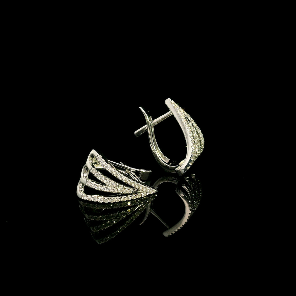 Multi-row diamond hoop earrings in 18K white gold with layered sweeping rows of round brilliant diamonds by Emirates Diamonds.