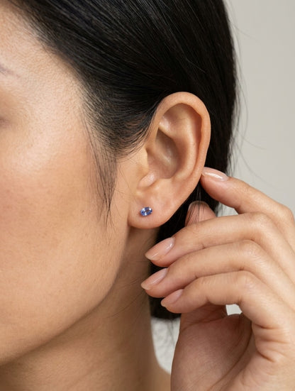 Oval tanzanite solitaire stud earrings in 18K white gold featuring natural blue-violet tanzanites by Emirates Diamonds.