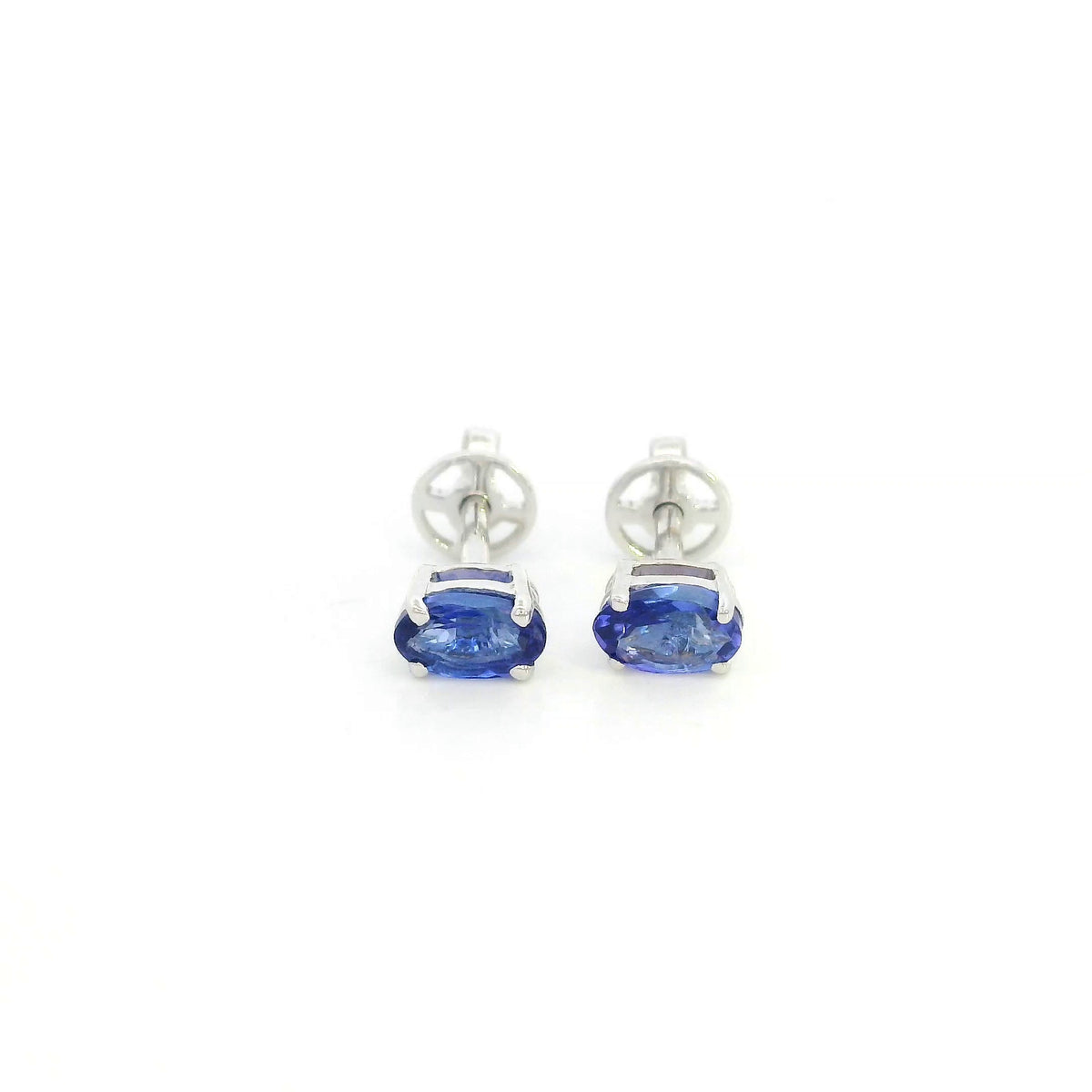 Oval tanzanite solitaire stud earrings in 18K white gold featuring natural blue-violet tanzanites by Emirates Diamonds.