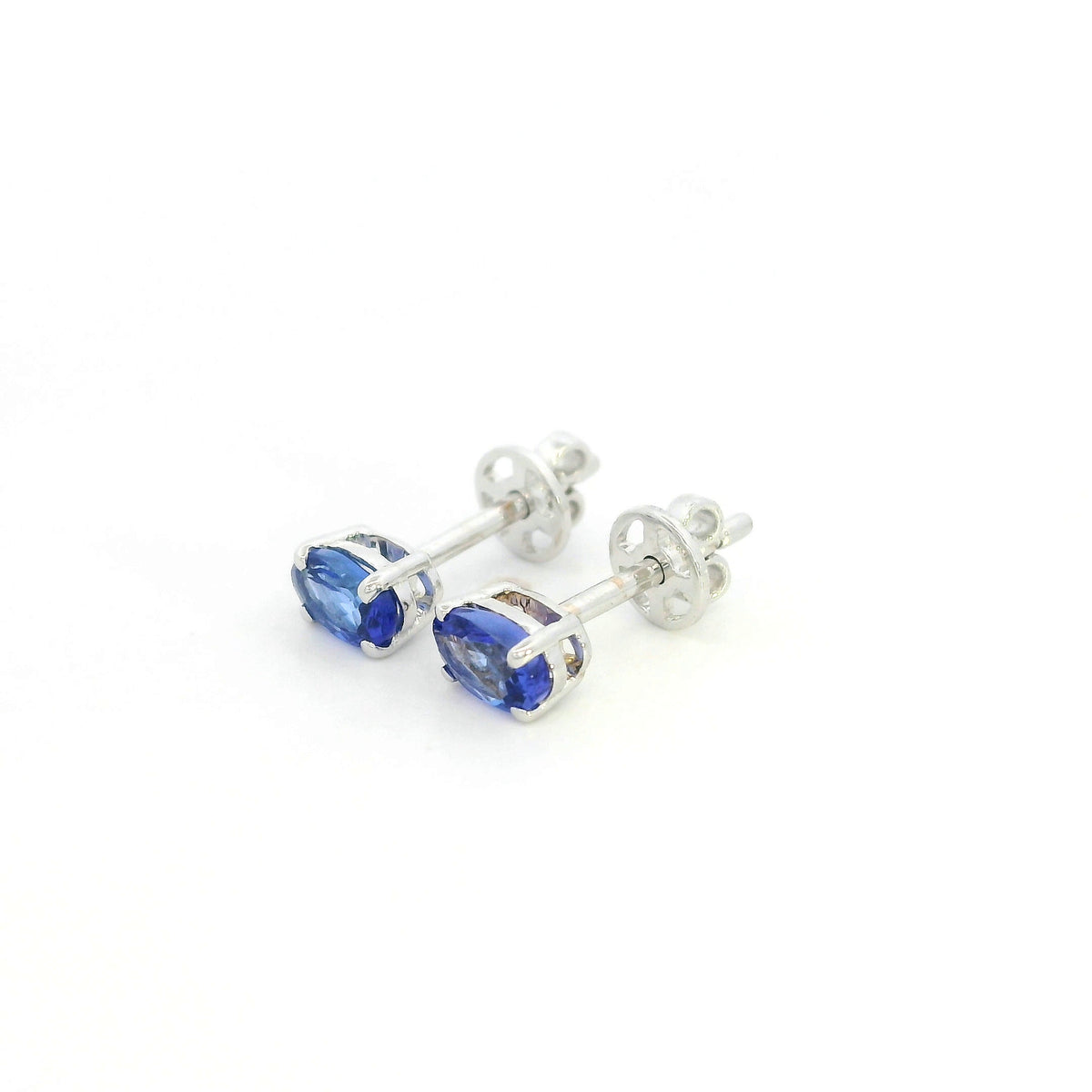 Oval tanzanite solitaire stud earrings in 18K white gold featuring natural blue-violet tanzanites by Emirates Diamonds.