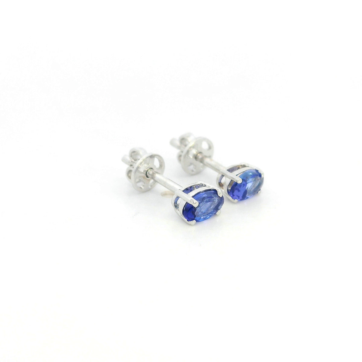 Oval tanzanite solitaire stud earrings in 18K white gold featuring natural blue-violet tanzanites by Emirates Diamonds.
