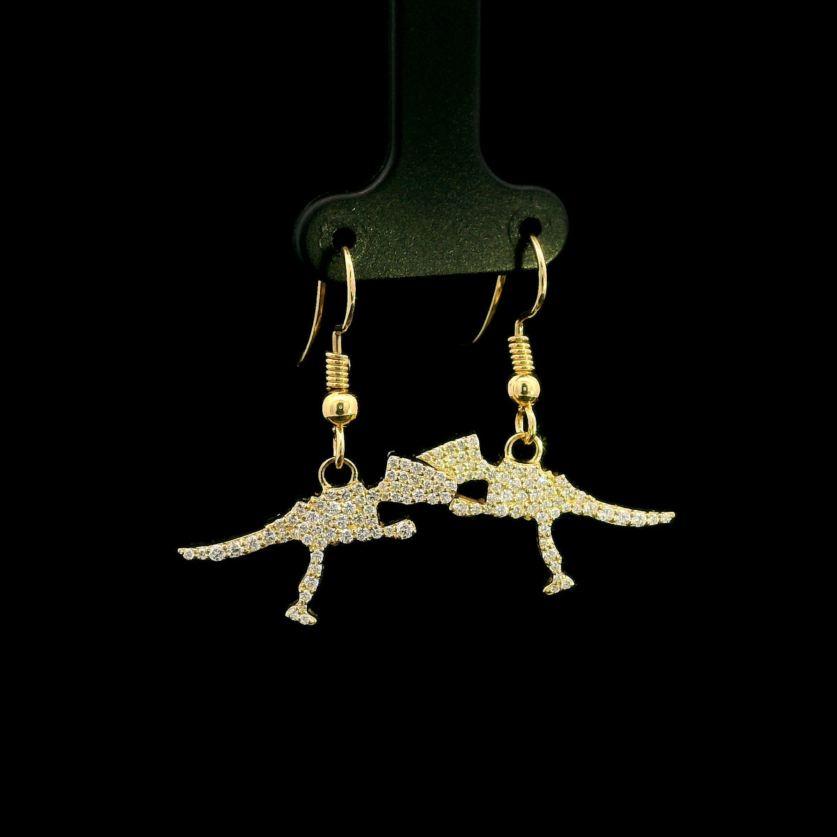 Diamond dinosaur dangle earrings in 18K yellow gold featuring sculptural dinosaur silhouettes set with round brilliant diamonds.