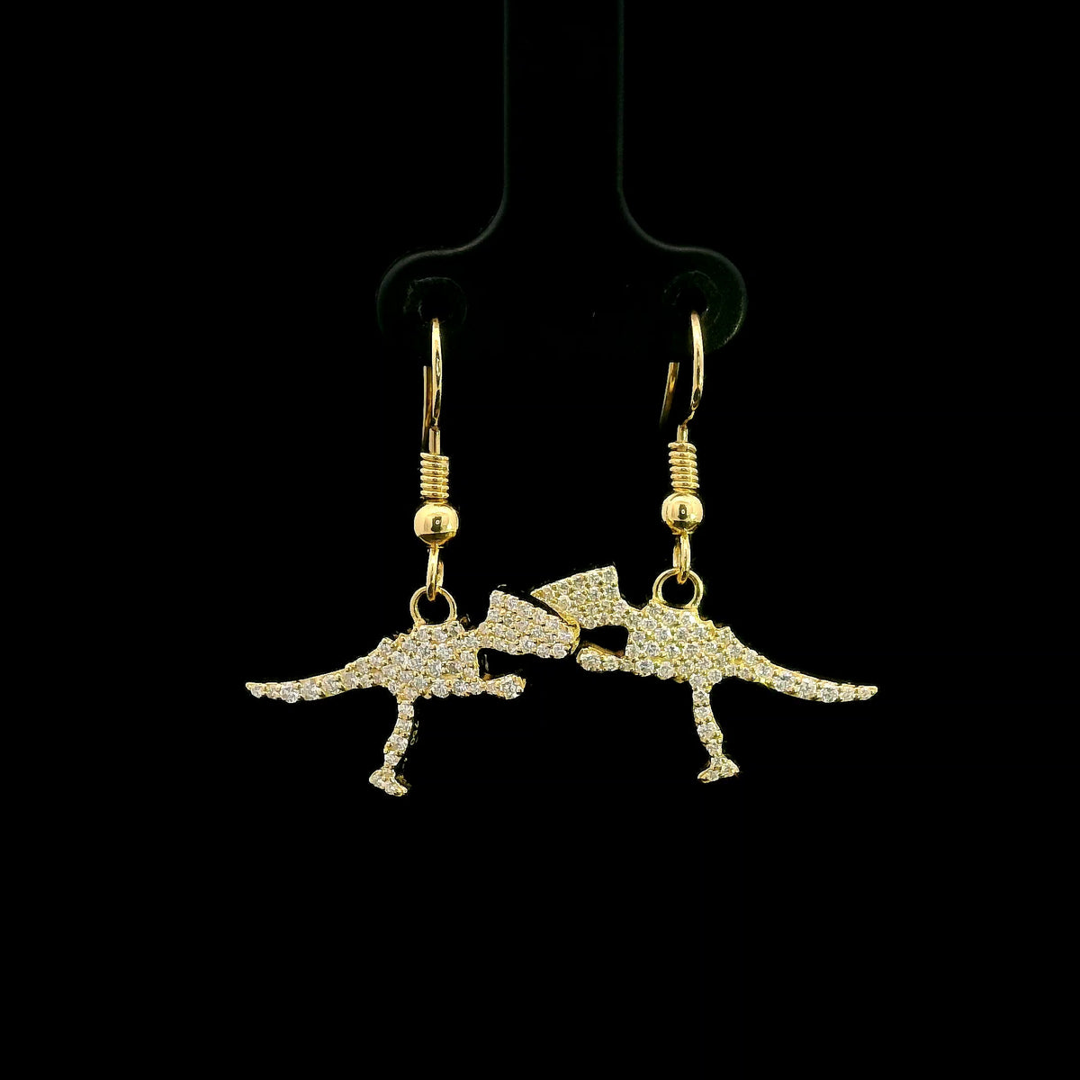 Diamond dinosaur dangle earrings in 18K yellow gold featuring sculptural dinosaur silhouettes set with round brilliant diamonds.