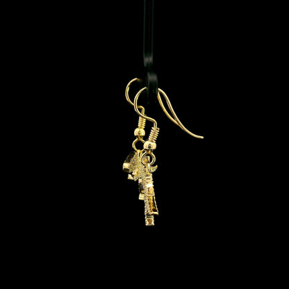 Diamond dinosaur dangle earrings in 18K yellow gold featuring sculptural dinosaur silhouettes set with round brilliant diamonds.