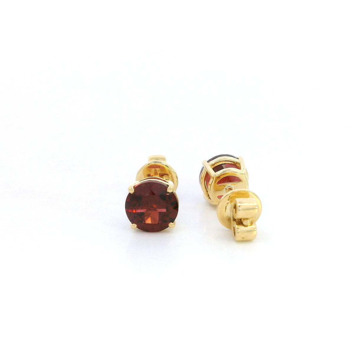 Round garnet solitaire stud earrings in 18K yellow gold with classic four-prong settings by Emirates Diamonds.