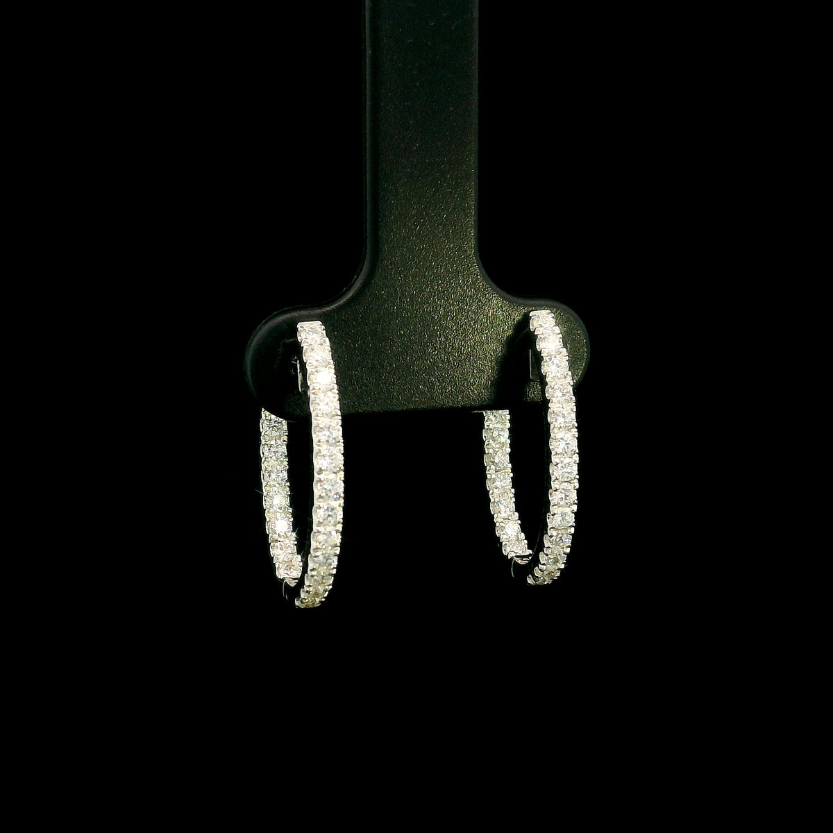 18K white gold inside out diamond hoop earrings with round brilliant diamonds set along the outer front and inner back surfaces.