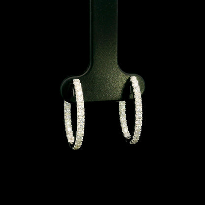 18K white gold inside out diamond hoop earrings with round brilliant diamonds set along the outer front and inner back surfaces.