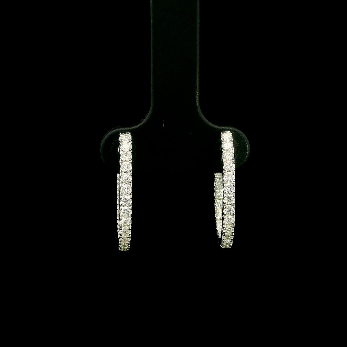 18K white gold inside out diamond hoop earrings with round brilliant diamonds set along the outer front and inner back surfaces.