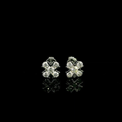 Four-petal diamond flower stud earrings in 18K white gold featuring round brilliant diamonds with minimal visible metal.