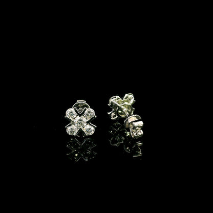 Four-petal diamond flower stud earrings in 18K white gold featuring round brilliant diamonds with minimal visible metal.