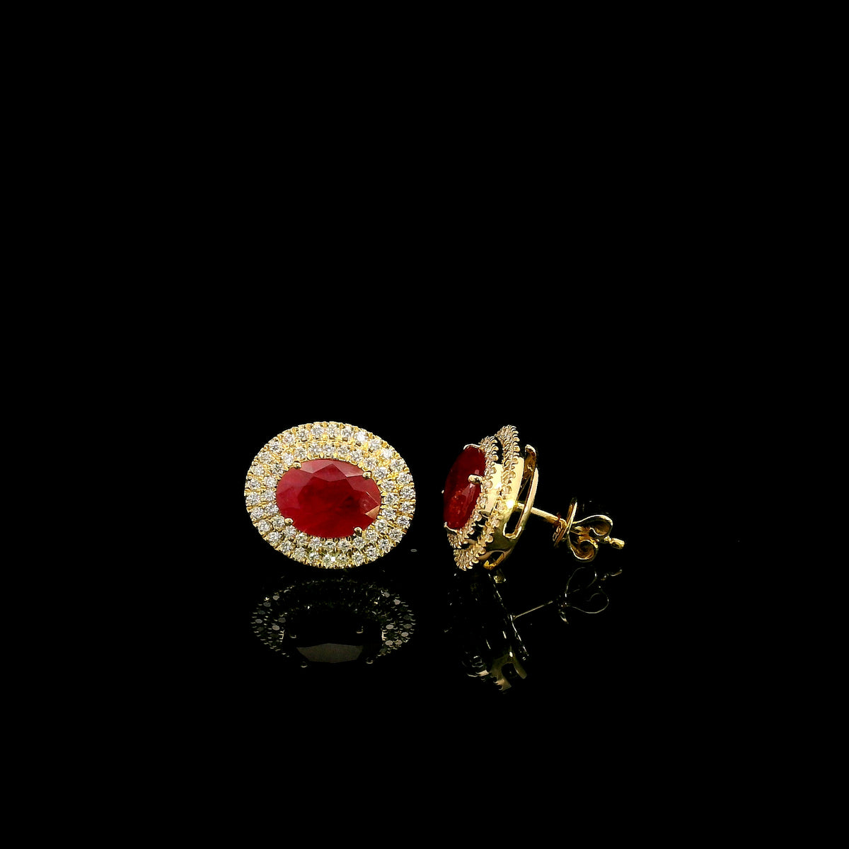 Oval ruby and double diamond halo stud earrings in 18K yellow gold by Emirates Diamonds.