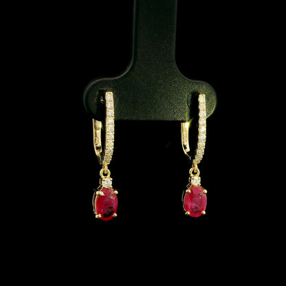Ruby and diamond drop earrings in 18K yellow gold with oval ruby drops and diamond set hoops
