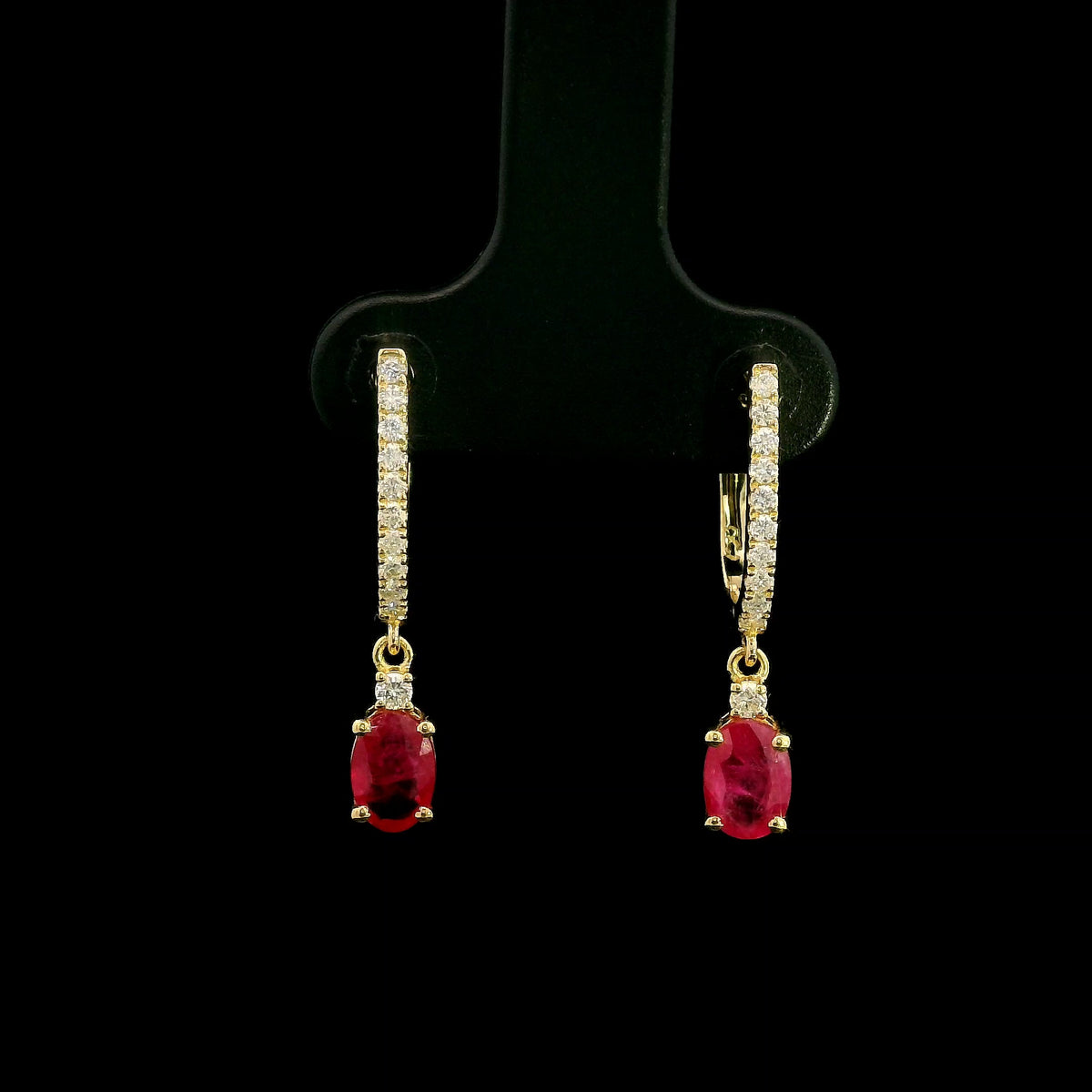 Ruby and diamond drop earrings in 18K yellow gold with oval ruby drops and diamond set hoops