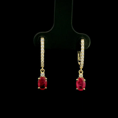 Ruby and diamond drop earrings in 18K yellow gold with oval ruby drops and diamond set hoops
