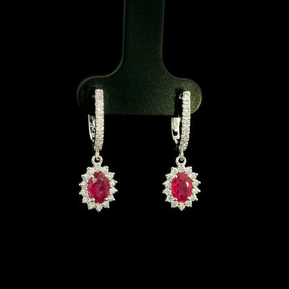 Ruby and diamond drop earrings in 18K white gold with oval ruby centres and diamond halos