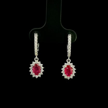 Ruby and diamond drop earrings in 18K white gold with oval ruby centres and diamond halos