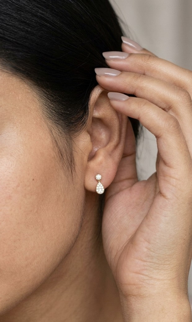 Diamond drop earrings with pear shaped teardrop design in 18K yellow gold