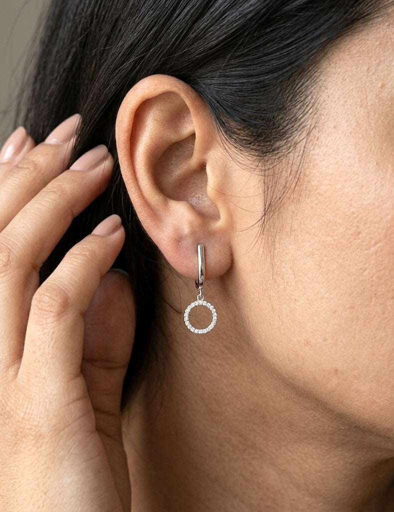Diamond drop earrings in 18K white gold with polished hoops and circular diamond drops