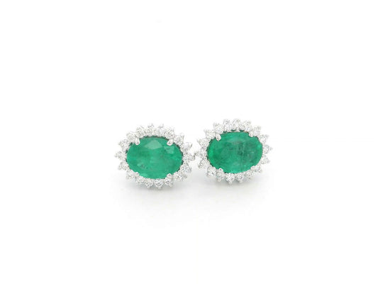 Emerald and diamond halo stud earrings in 18K white gold featuring 2.31 carat emeralds and 0.36 carat diamonds by Emirates Diamonds.