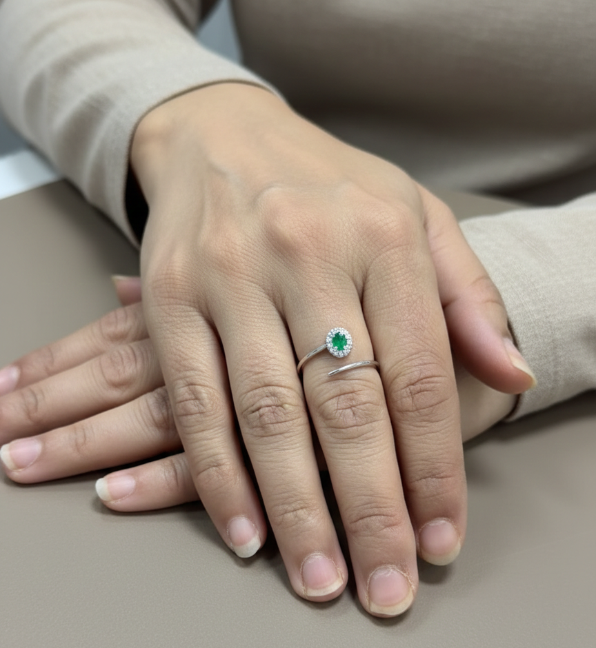 Emerald diamond halo wrap ring in 18K white gold with oval emerald and diamond halo
