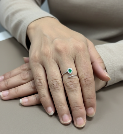 Emerald diamond halo wrap ring in 18K white gold with oval emerald and diamond halo