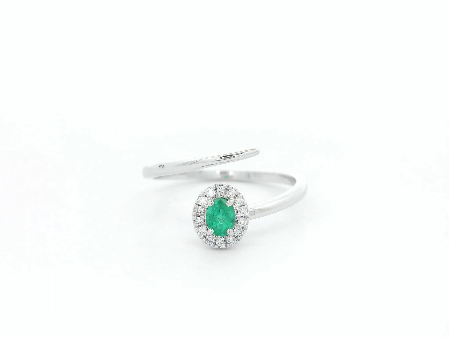 Emerald diamond halo wrap ring in 18K white gold with oval emerald and diamond halo
