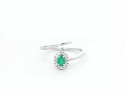 Emerald diamond halo wrap ring in 18K white gold with oval emerald and diamond halo