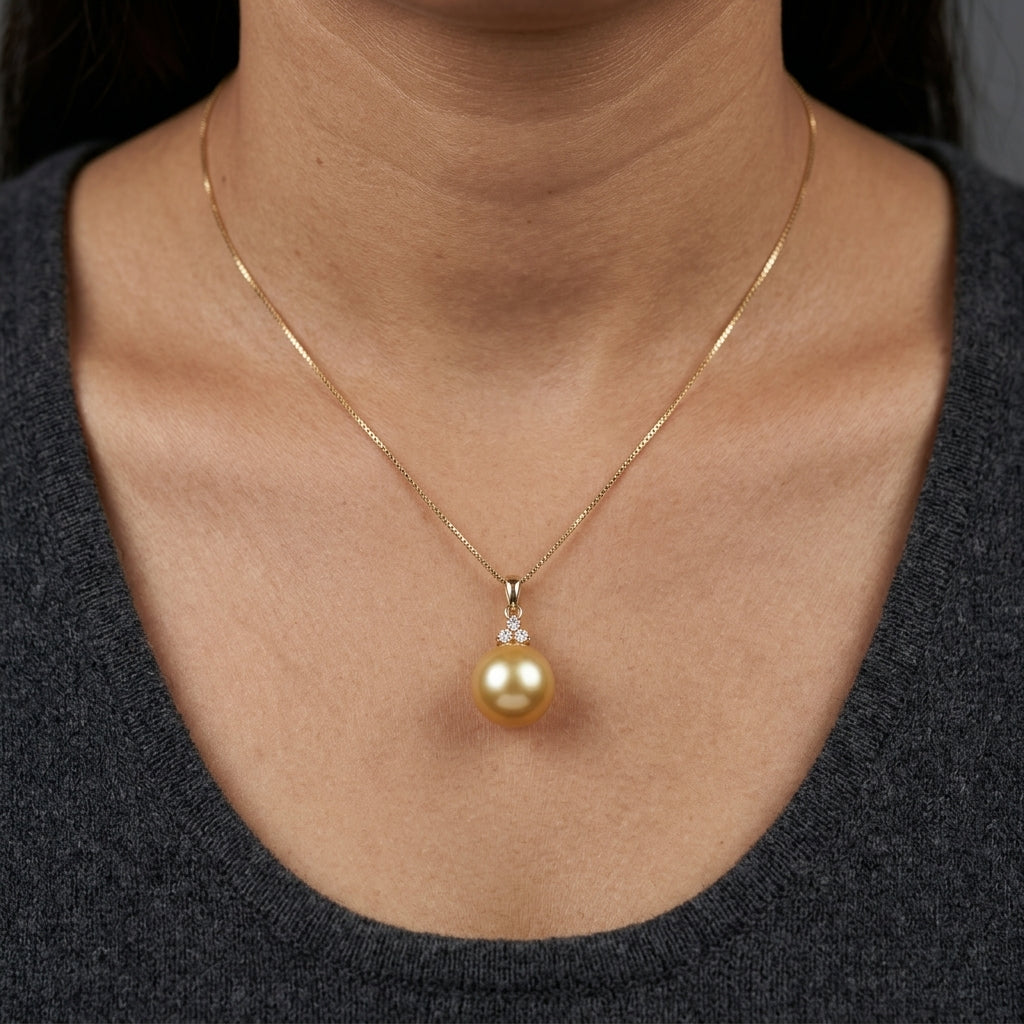 South Sea Golden Pearl and diamond pendant in 18K yellow gold featuring a 10 x 13 mm golden pearl and round diamond accents